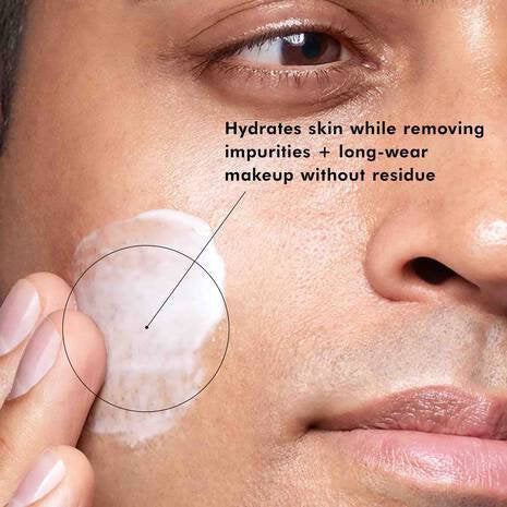 Close-up of a person applying a skincare product to their face with text highlighting its benefits.